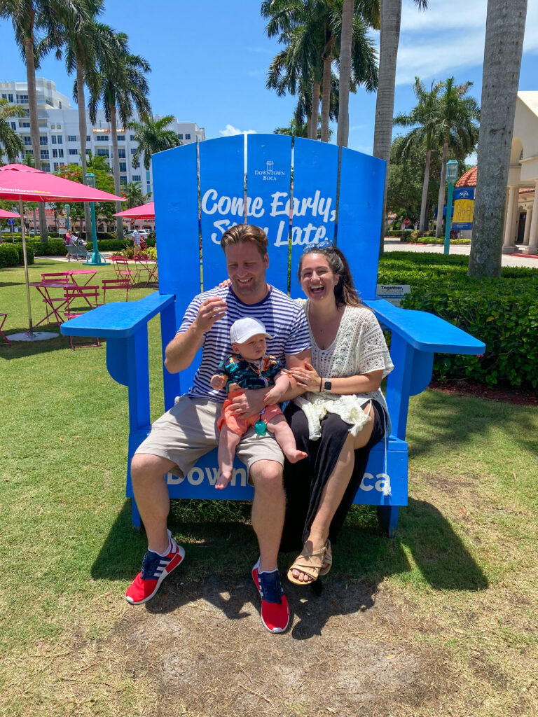 20 fun family restaurants in Palm Beach County- Mizner park-family posing on a giant chair 